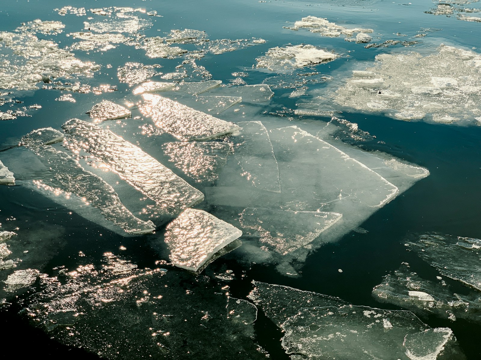 Hudson River with ice floes and a distant skyline