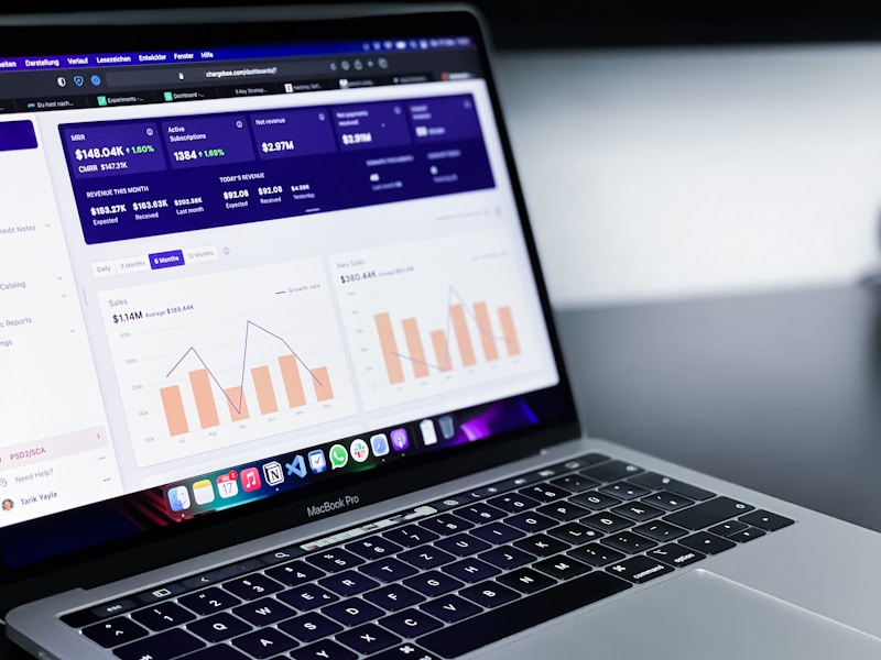 Laptop screen showing a marketing analytics dashboard with revenue and subscription charts